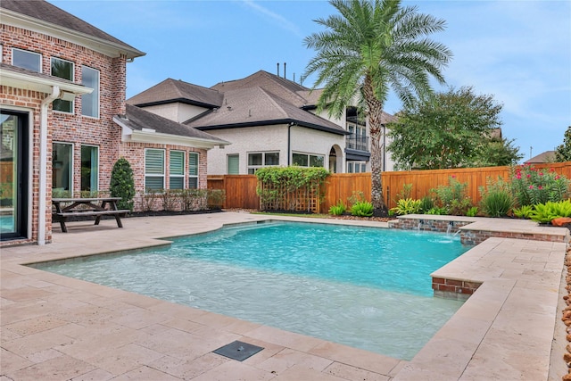 view of pool with pool water feature and a patio