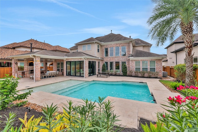 view of swimming pool featuring a fireplace and a patio area