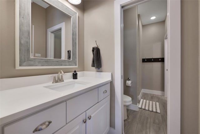 bathroom featuring vanity and toilet