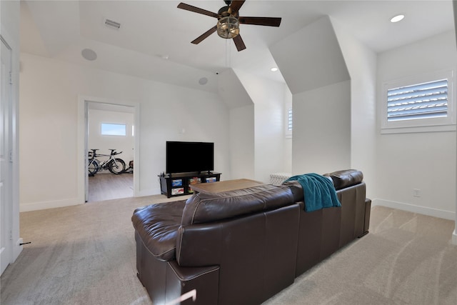 living room with plenty of natural light, light colored carpet, and ceiling fan