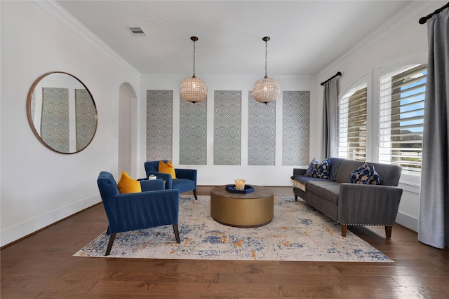 living area with crown molding and dark hardwood / wood-style flooring