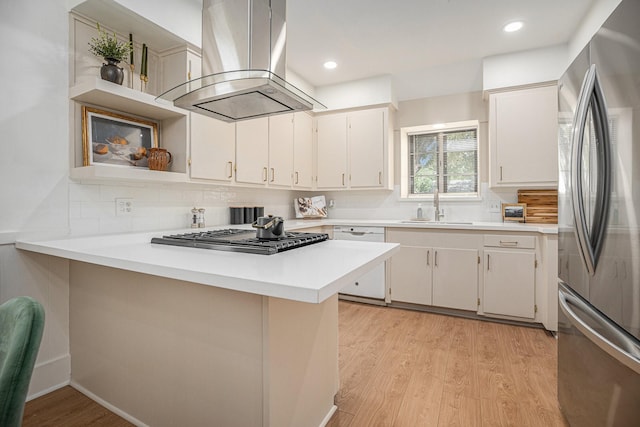 kitchen with white cabinetry, island exhaust hood, and appliances with stainless steel finishes