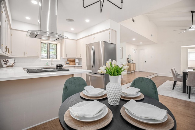 dining area with ceiling fan and wood-type flooring