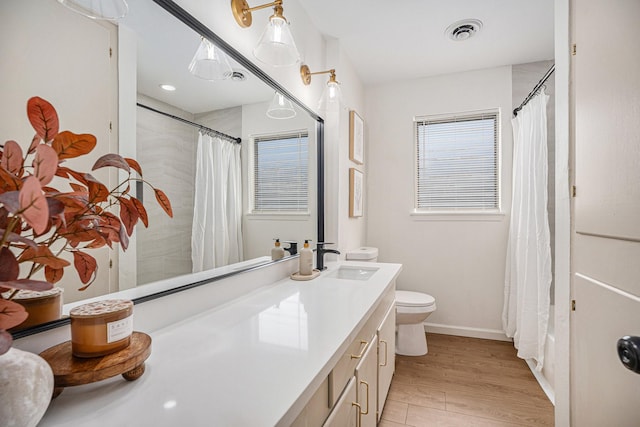 bathroom featuring vanity, toilet, and wood-type flooring