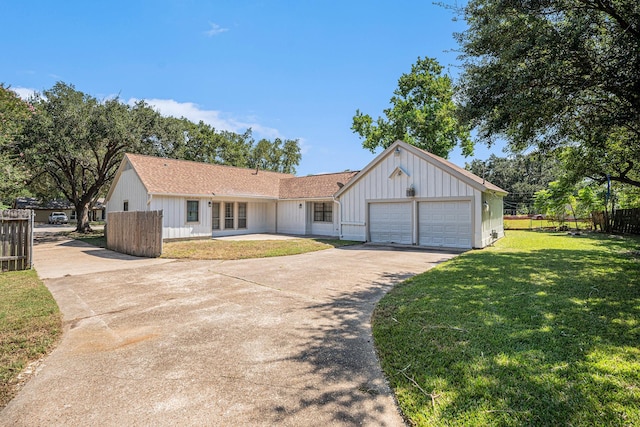 single story home featuring a garage and a front lawn