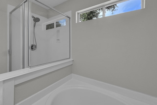 bathroom with shower with separate bathtub