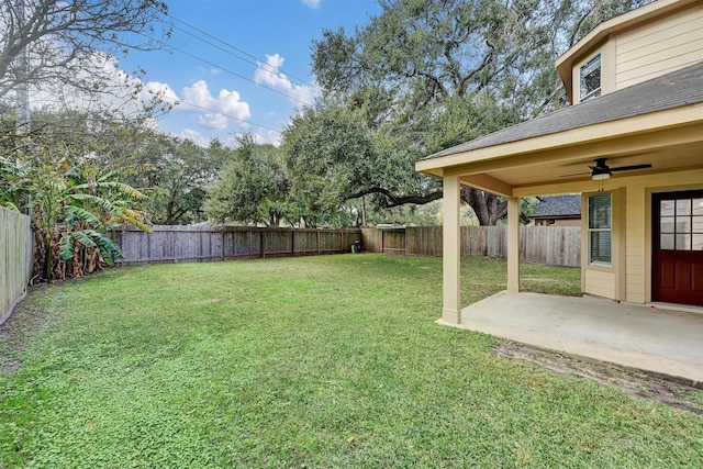 view of yard with ceiling fan and a patio area