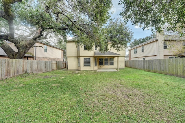 rear view of property with a patio area and a yard