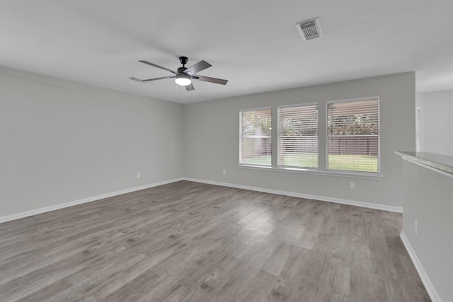 spare room with light hardwood / wood-style floors and ceiling fan