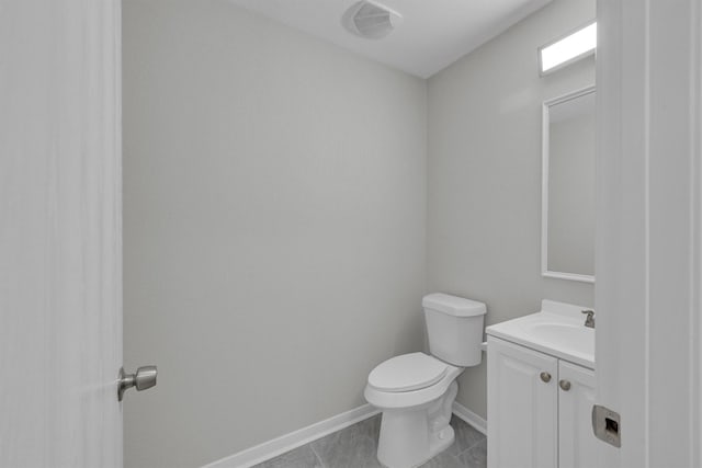 bathroom with vanity, toilet, and tile patterned floors