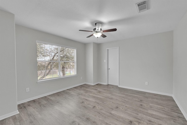 empty room featuring ceiling fan and light hardwood / wood-style floors