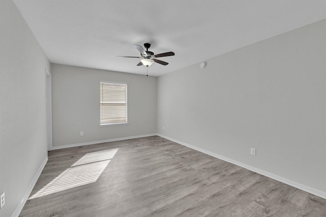 empty room featuring light hardwood / wood-style flooring and ceiling fan