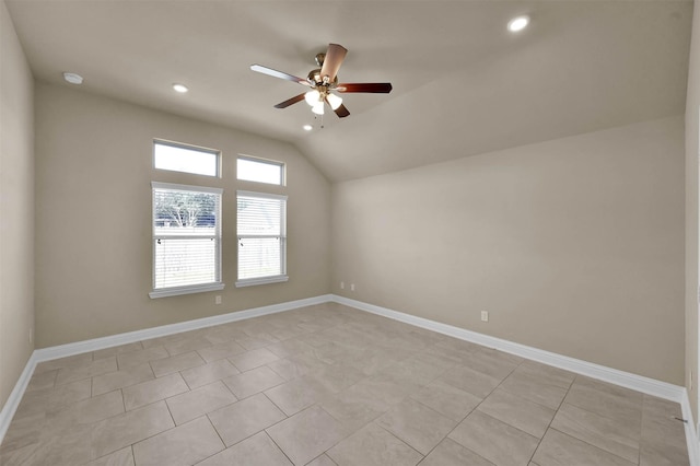 spare room featuring lofted ceiling, ceiling fan, and light tile patterned flooring