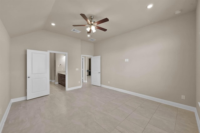 unfurnished bedroom featuring lofted ceiling, connected bathroom, ceiling fan, and light tile patterned floors