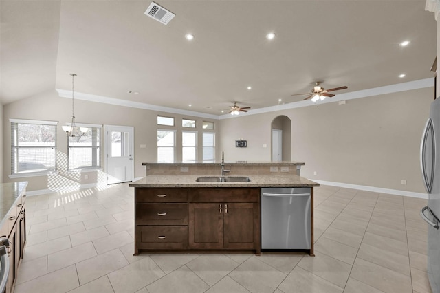 kitchen with stainless steel appliances, hanging light fixtures, sink, and light tile patterned floors