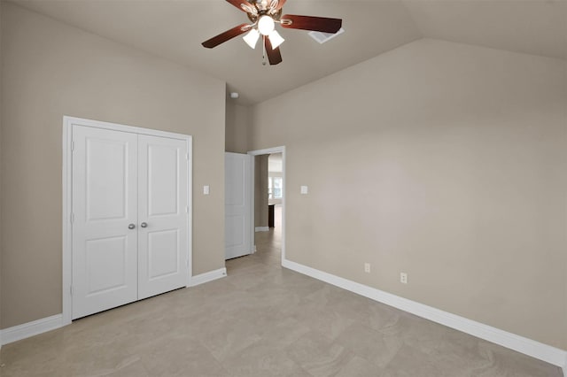 unfurnished bedroom featuring ceiling fan, lofted ceiling, and a closet