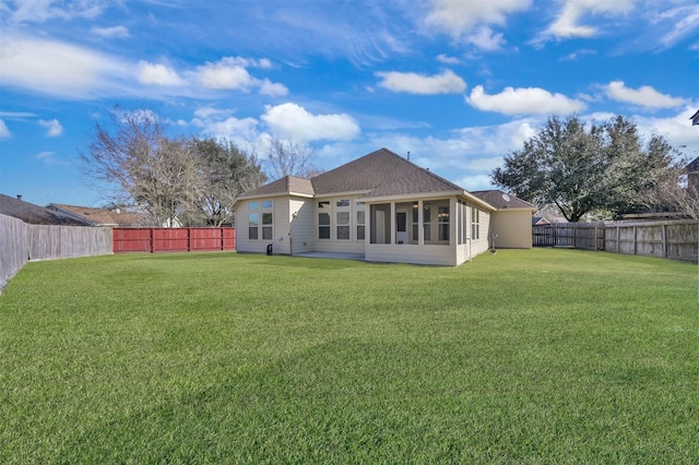 back of property with a lawn