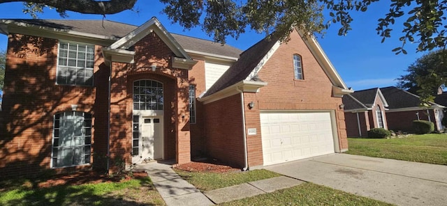 view of front of property featuring a garage and a front lawn