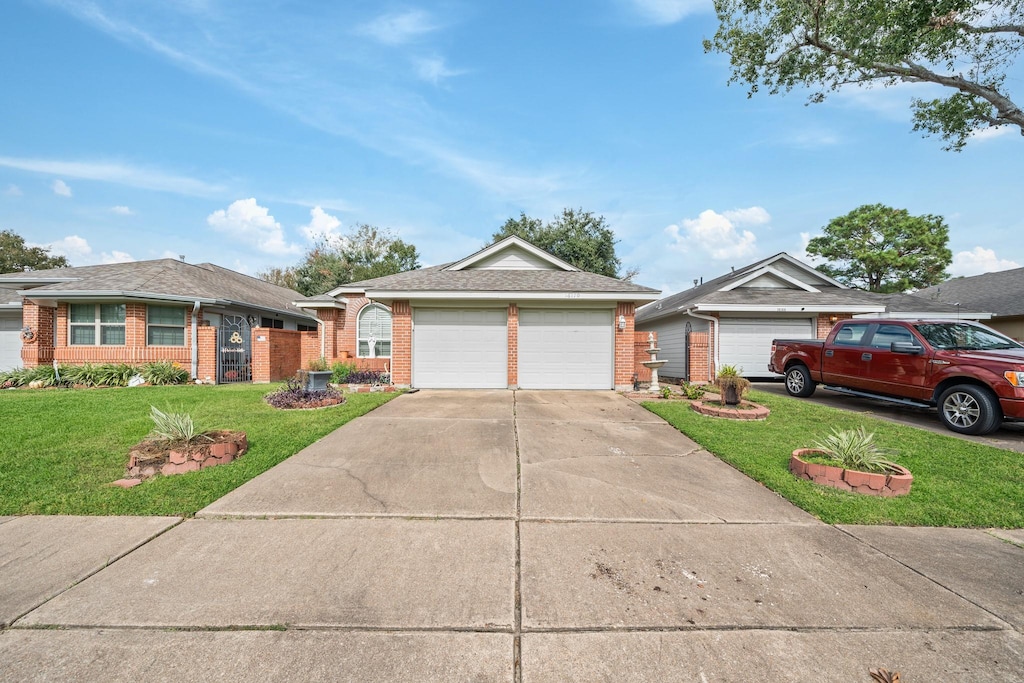 ranch-style home featuring a garage and a front yard