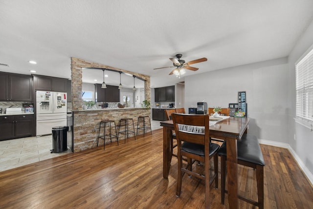 dining room featuring ceiling fan and hardwood / wood-style floors