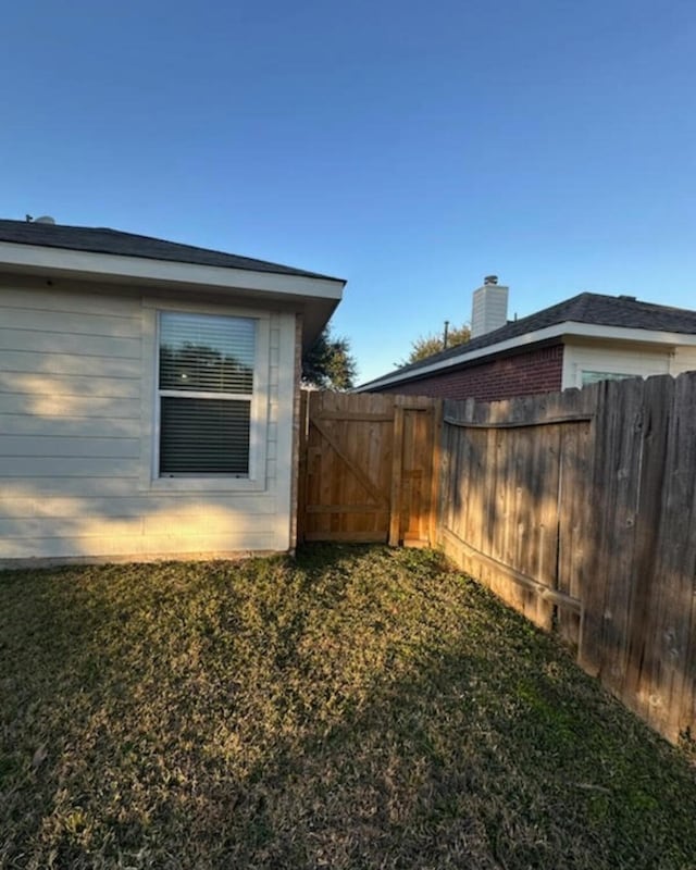 view of side of home with a lawn