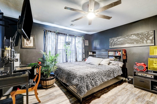 bedroom featuring ceiling fan and light hardwood / wood-style floors