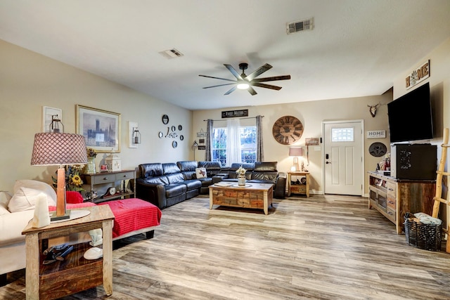 living room featuring ceiling fan and light wood-type flooring