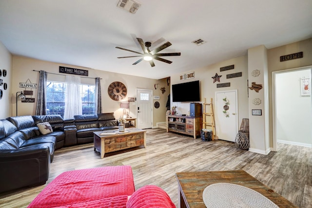 living room with light wood-type flooring and ceiling fan