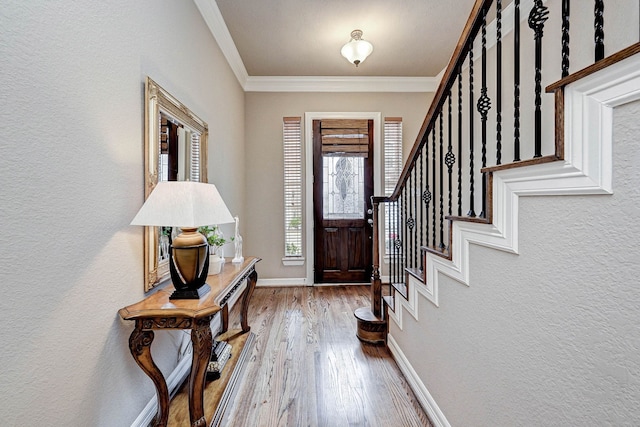 foyer entrance featuring light hardwood / wood-style floors and ornamental molding