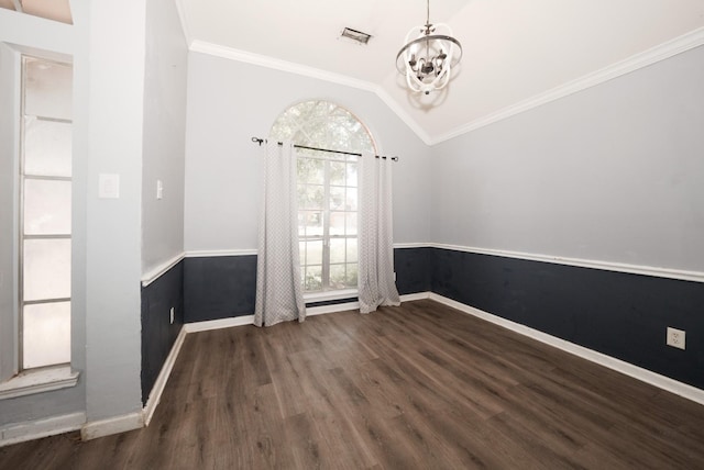 interior space featuring dark hardwood / wood-style floors, ornamental molding, an inviting chandelier, and vaulted ceiling