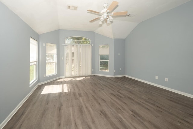 empty room with vaulted ceiling, ceiling fan, and dark hardwood / wood-style flooring