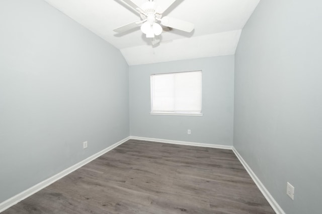 spare room with ceiling fan, dark hardwood / wood-style floors, and lofted ceiling