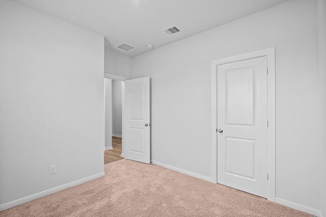 empty room with light colored carpet