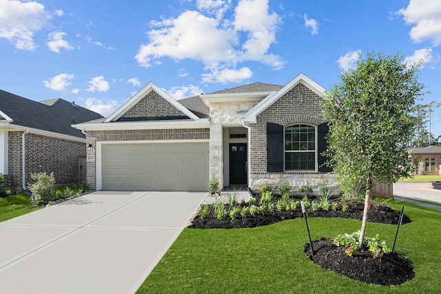 view of front of house featuring a garage and a front lawn