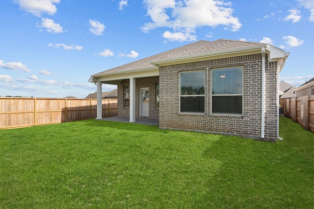 back of house featuring a yard and a patio