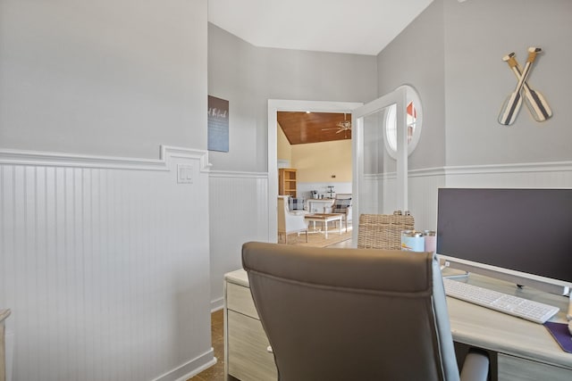 office space featuring vaulted ceiling and ceiling fan