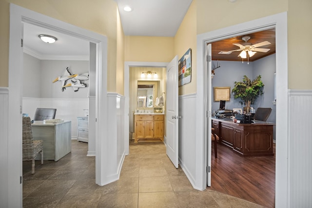 hall with light tile patterned floors and crown molding