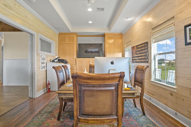 dining area featuring dark hardwood / wood-style flooring, crown molding, and wood walls