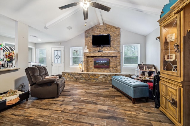 living room with ceiling fan, vaulted ceiling with beams, dark hardwood / wood-style floors, and a fireplace