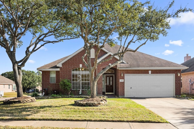 view of front of home with a front yard and a garage