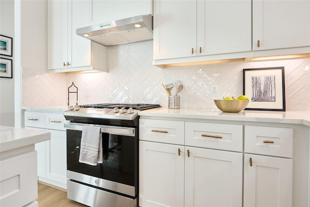 kitchen with white cabinetry, light wood-type flooring, tasteful backsplash, and stainless steel gas stove