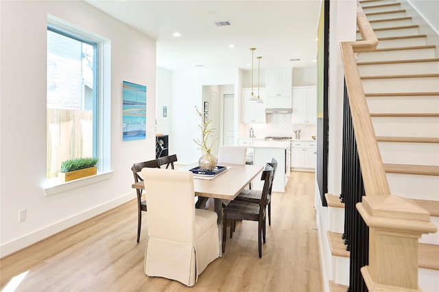 dining area with light hardwood / wood-style floors