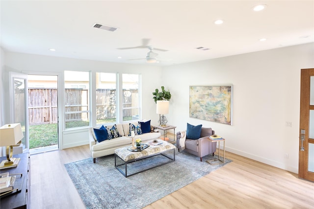 living room featuring ceiling fan and light hardwood / wood-style flooring