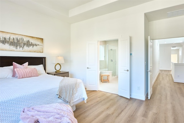 bedroom featuring light hardwood / wood-style floors and a high ceiling