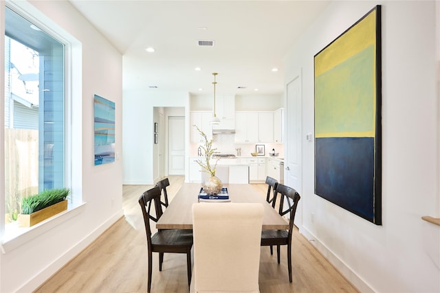 dining area featuring light wood-type flooring