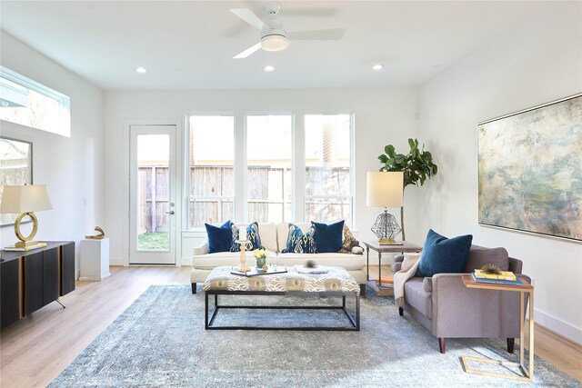 living room featuring ceiling fan and light hardwood / wood-style flooring