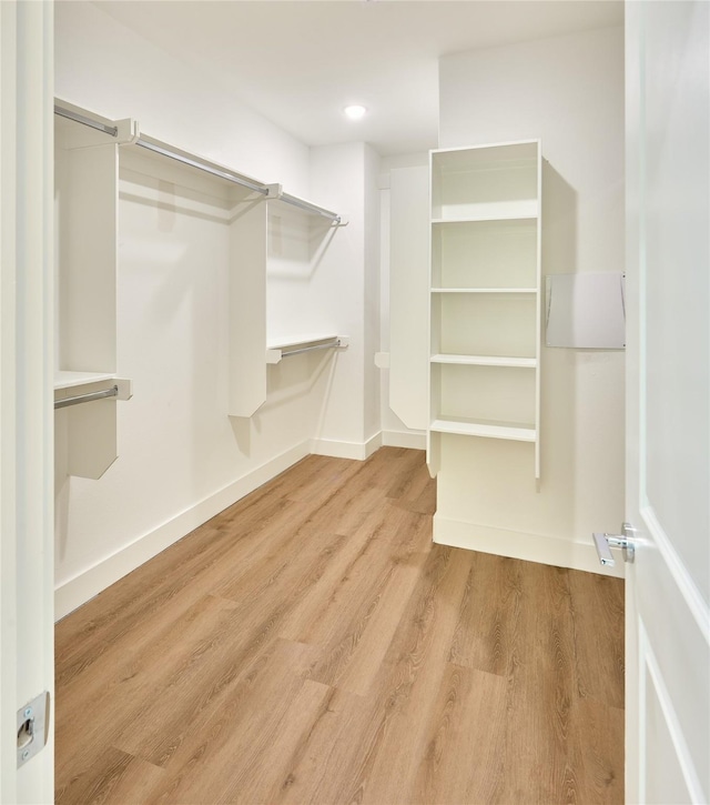 spacious closet with light hardwood / wood-style flooring