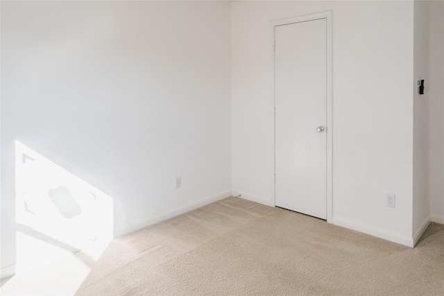 spare room with light carpet