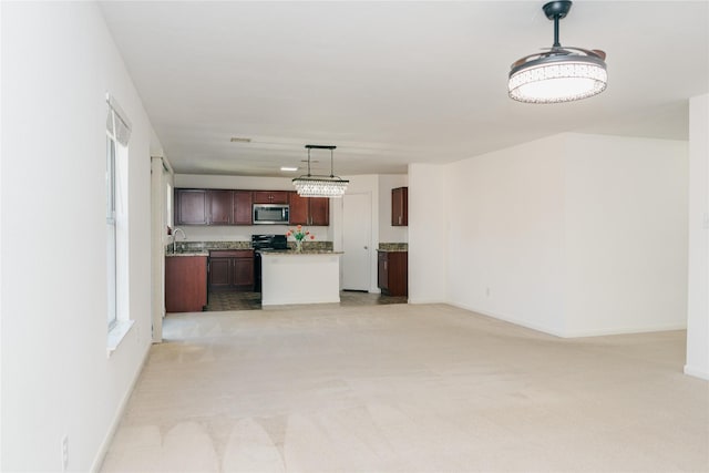 unfurnished living room featuring sink and light carpet