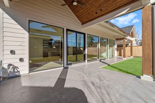 unfurnished sunroom with vaulted ceiling, wooden ceiling, and ceiling fan